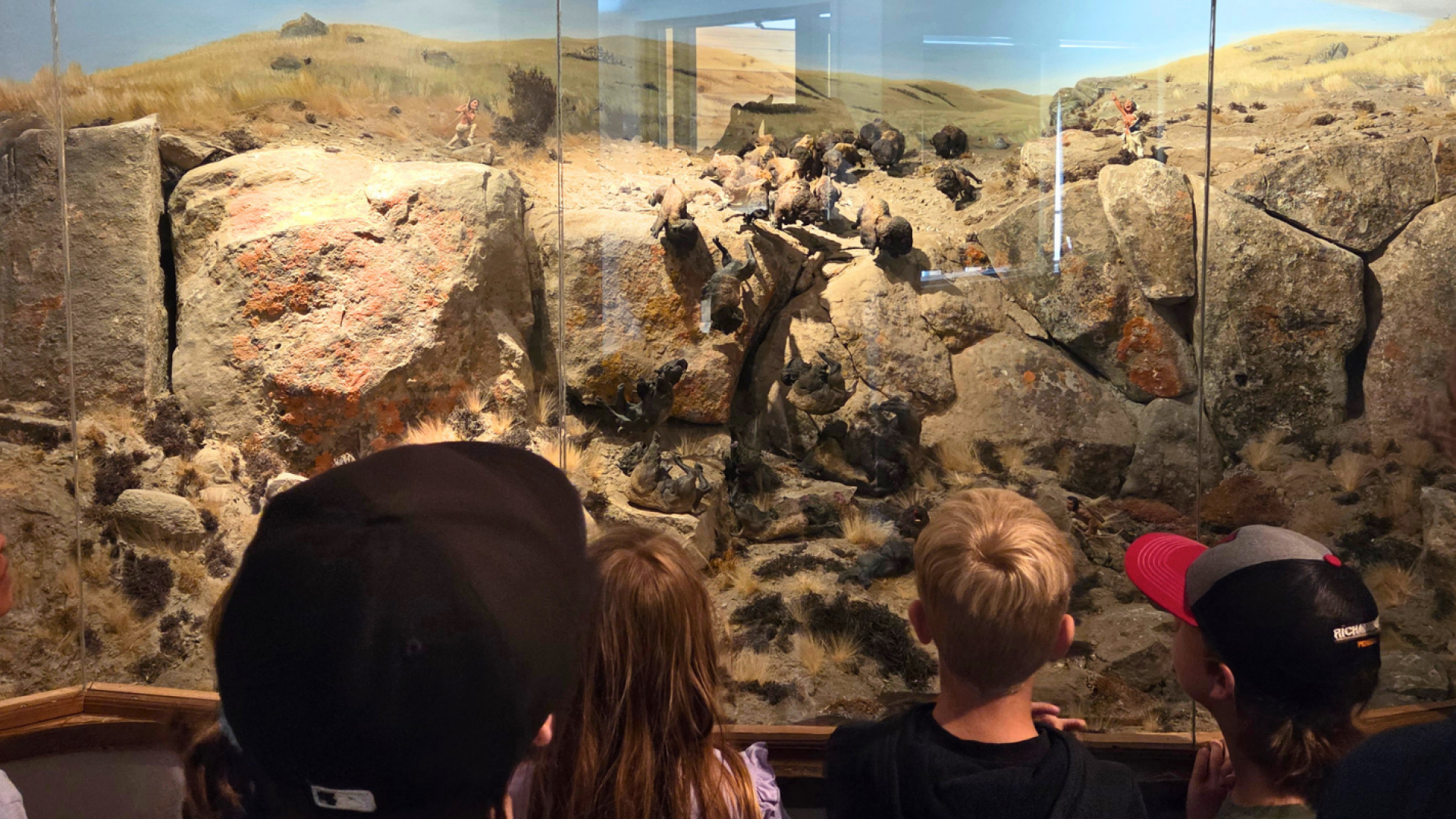Children looking at a display of Head-Smashed-In Buffalo Jump.