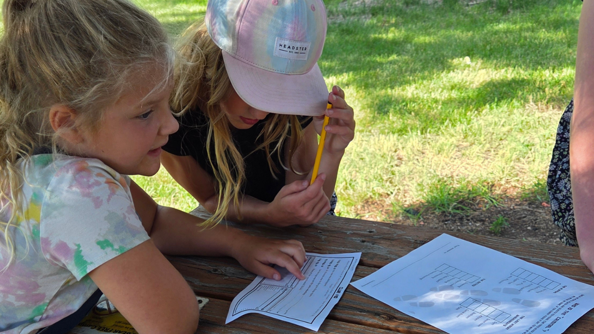 Children outdoors doing a scavenger hunt.